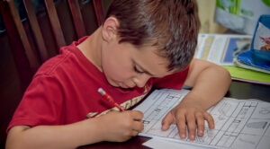 little boy uses homework tips to improve grades