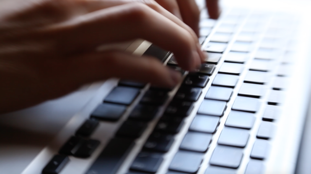 person uses laptop to look up research on autism treatments