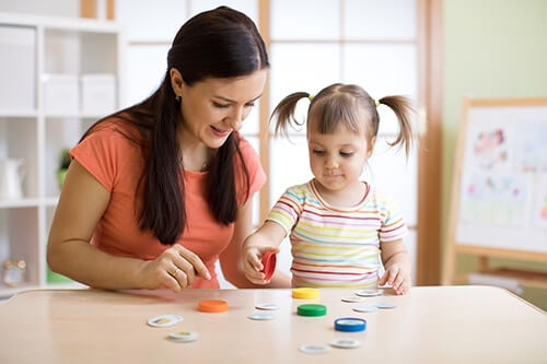 woman working with child on aba therapy for autism process