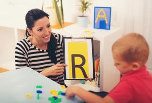woman working with child in verbal beginnings career