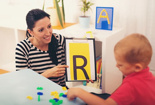 woman working with child enjoys verbal beginnings careers