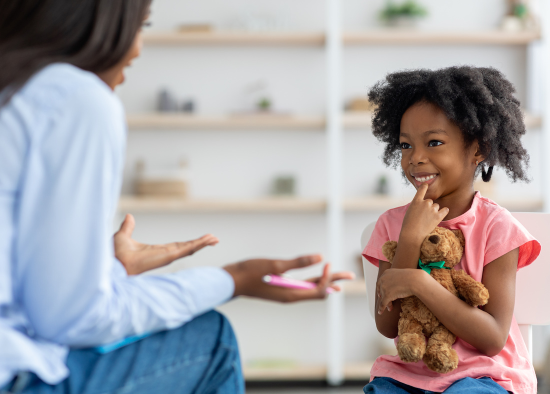 Cheerful cute little girl at child psychologists office