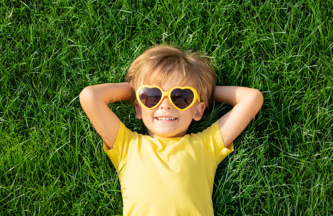 Happy child playing outdoor in spring park