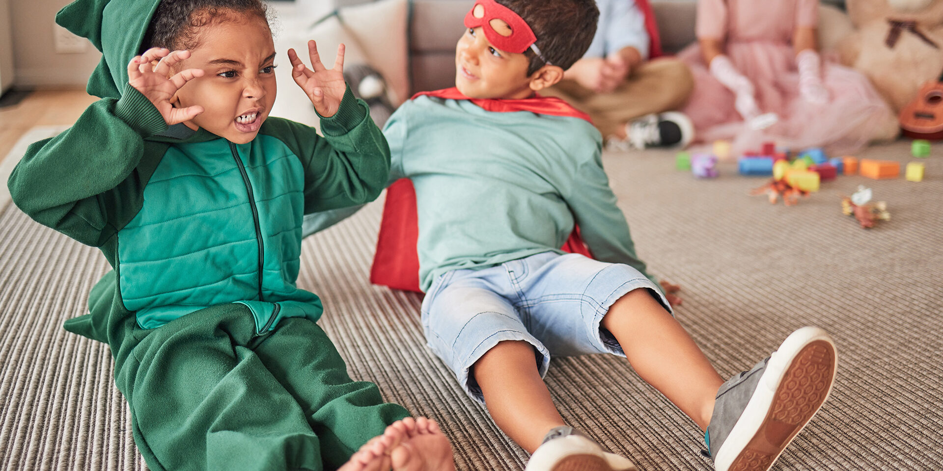 verbal beginnings children playing in halloween costumes dragon and super hero 2026 533894532 verbal beginnings children playing in halloween costumes dragon and super hero 2026 533894532